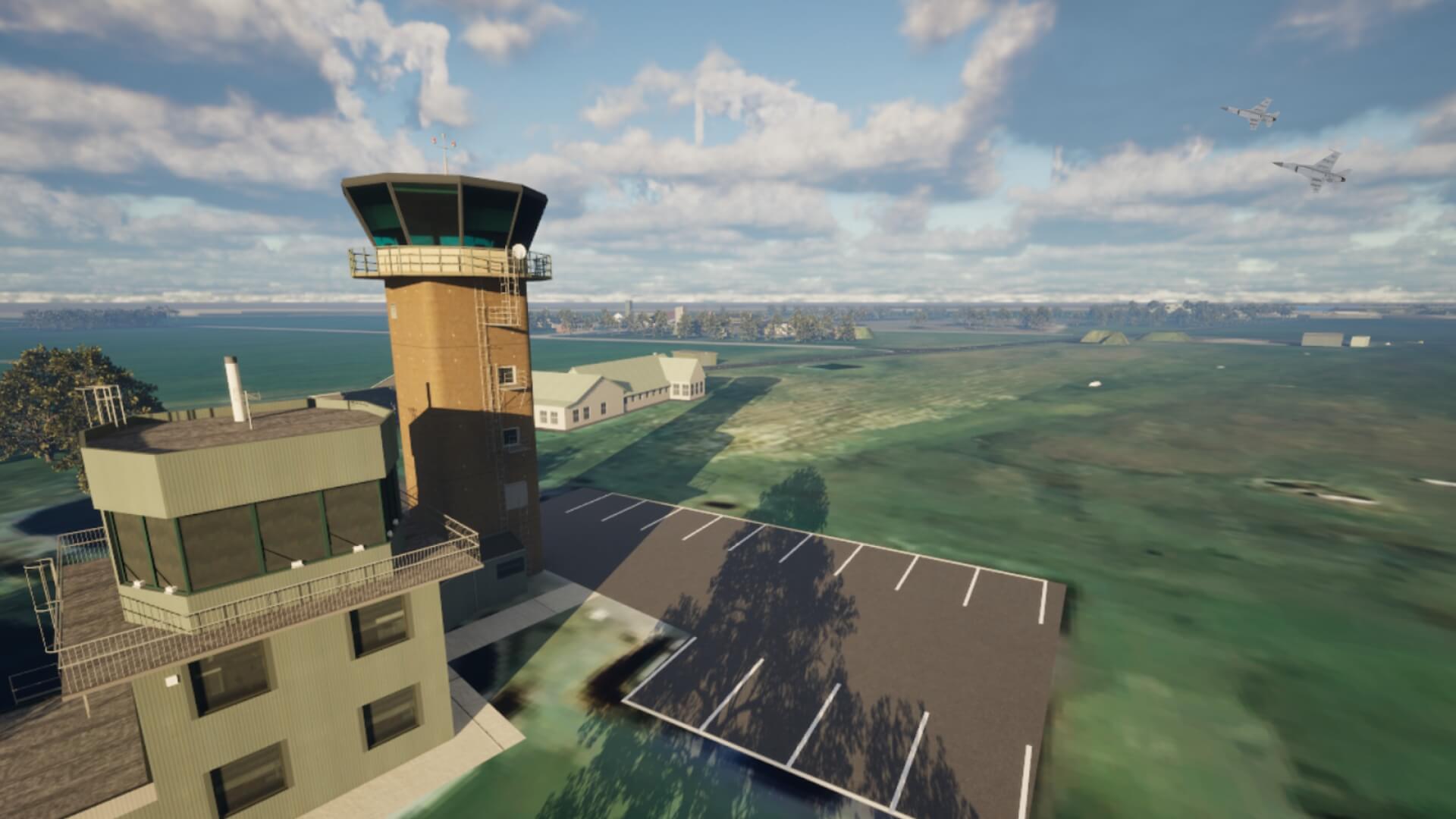 Aerial view of an airport control tower with nearby buildings and two jets flying in the sky.