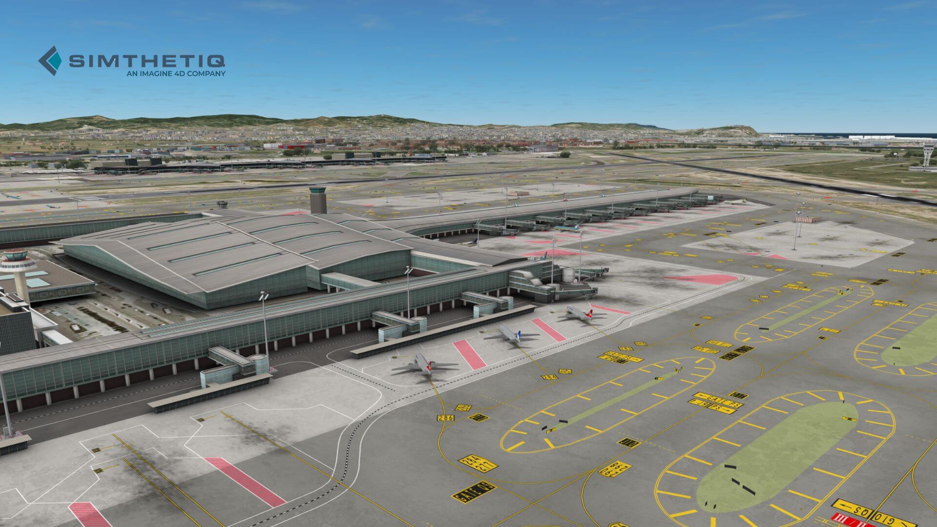 Aerial view of an airport with multiple aircraft, taxiways, and terminal buildings under a clear blue sky.