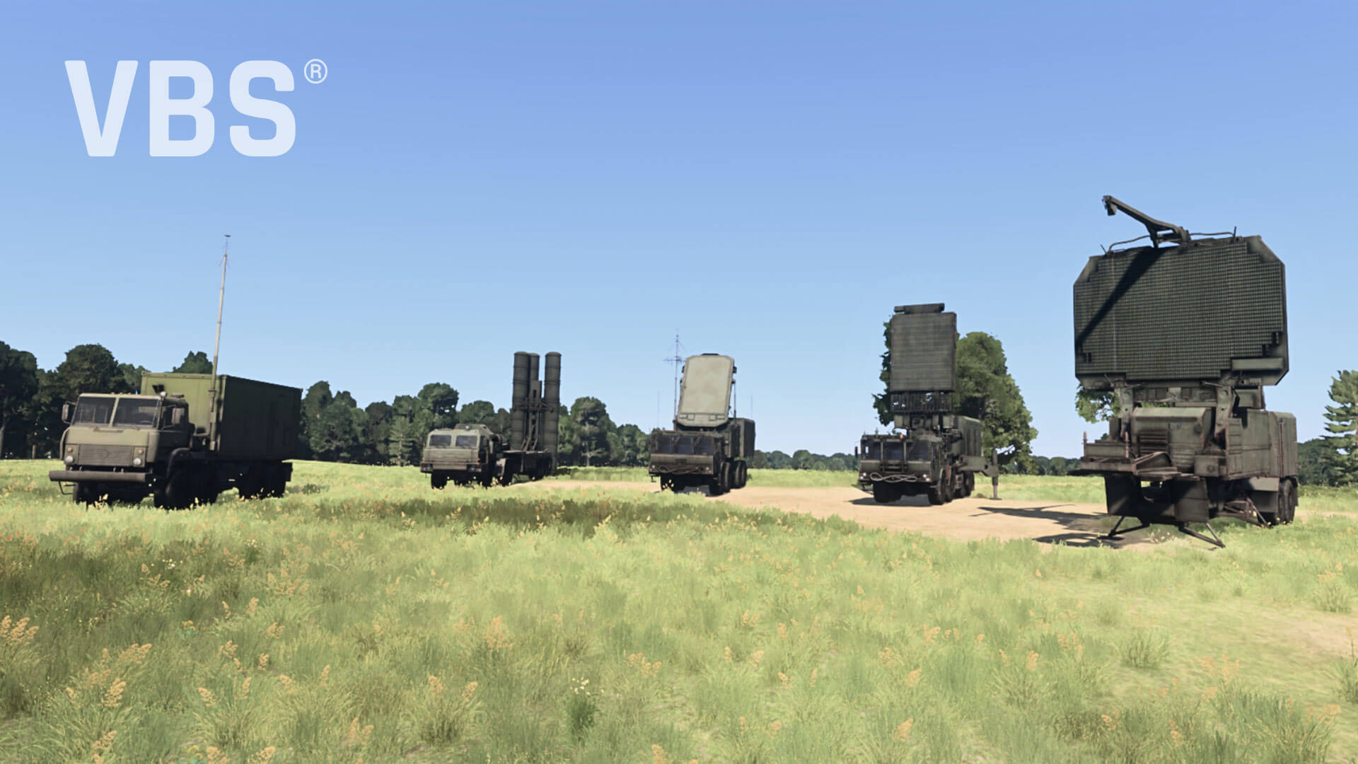 lineup of military vehicles, including radar and communication trucks, set in a grassy field under a clear blue sky.