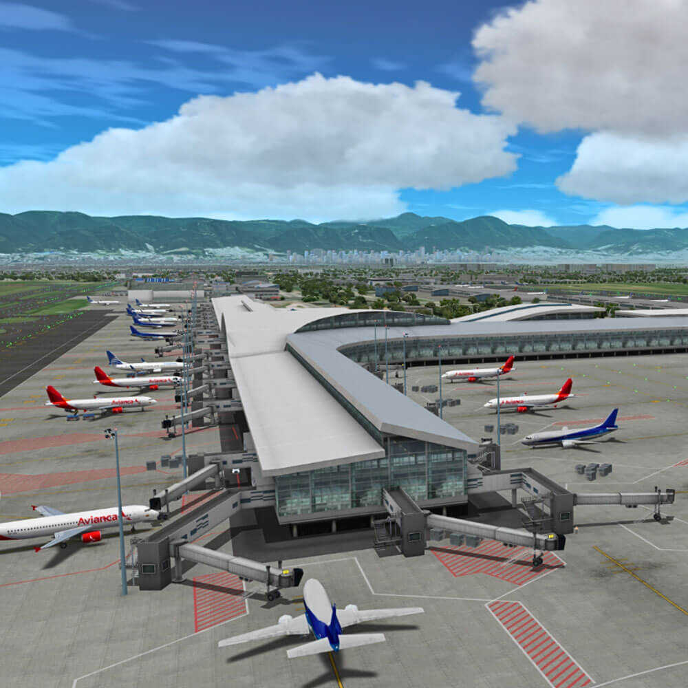 Aerial view of an airport with multiple planes parked at gates and mountains in the background under a cloudy sky.